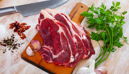 Raw beef fillet with onion and pepper ready for cooking on wooden table