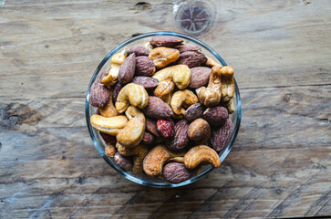 Assorted nuts in glass bowl on kitchen table