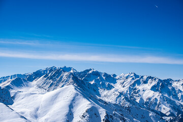Fototapeta premium Snowy mountain peaks not far from Almaty, mountain views from kumbel peak. A popular tourist route in the mountains.