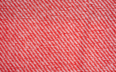 Texture of woolen blanket, bright woolen threads woven into fabric. Beautiful bright red with white stripes woolen blanket.