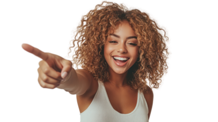 Cheerful woman with curly hair pointing and smiling, exuding happiness and enthusiasm.