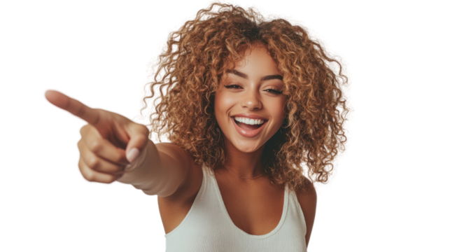 Cheerful woman with curly hair pointing and smiling, exuding happiness and enthusiasm.