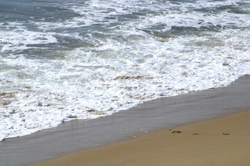 edge of ocean tidal waves on sandy beach