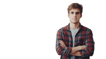 Young man with arms crossed looking confidently at the camera, wearing a plaid shirt against a white background.