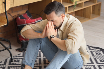 Young man having panic attack in office