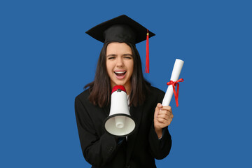 Female student in graduation hat with diploma and megaphone on blue background