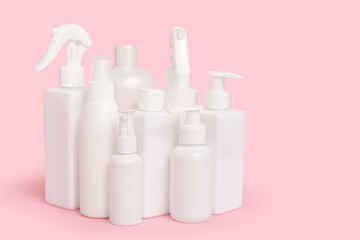 Different cosmetic products on pink  background