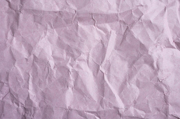 Full frame shot of crumpled light pink paper sheet texture and background.