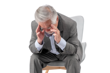 Elderly Businessman Sitting on Chair with Hands on Head, Showing Signs of Stress or Headache, in a Formal Suit isolated on a transparent background - Senior Health, Mental Wellness, Stress Management