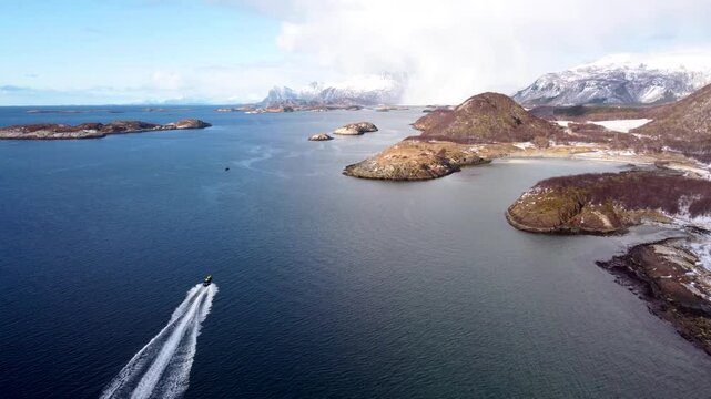 This 4K drone video showcases the RIB safari in arctic ocean of Norway. Snow-covered mountains, frozen fjords, and Arctic beauty with the fast running boat in the stuning detail.