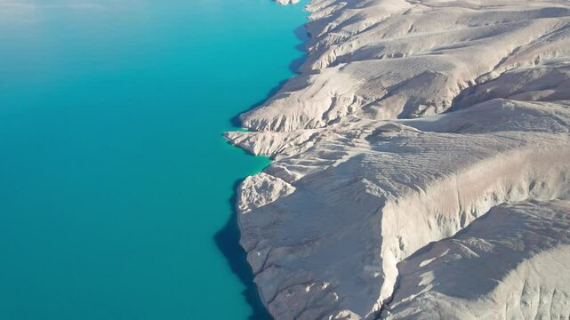 Drone view of Bulungkol or Bandier blue Lake on sunny day in Tashkurgan County, Kashgar, Southern Xinjiang, China. Aerial landscape of landmark on Pamir plateau, 4k real time footage, travel concept.