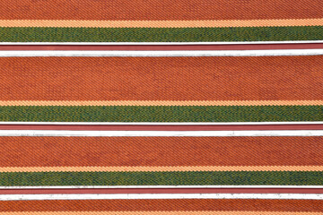repetitive wave pattern of colorful roof clay tiles, thai temple roofing or grand palace, asian traditional exterior architecture detail, abstract texture background © andy0man