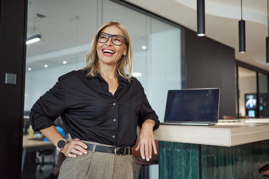 A confident and professional individual thriving in a modern and stylish office environment