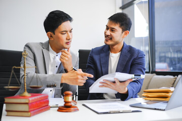 A businessman and a male lawyer or a team of judges discuss a joint investment meeting. They provide legal advice, review contracts, and ensure compliance with business laws and regulations