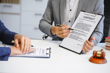 A businessman and a male lawyer or a team of judges discuss a joint investment meeting. They...