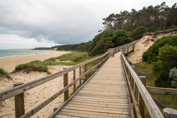 Fototapeta premium wooden footbridge at beach exemplifies balance between human construction and natural surroundings, showcasing how these structures provide accessibility without harming environment