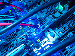 Blue LED Lights in Server Rack with Data Cables and Technology
