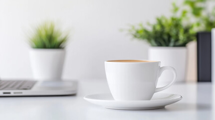 close up photo of white coffee cup on saucer, with laptop and green plants in background, creating serene workspace atmosphere
