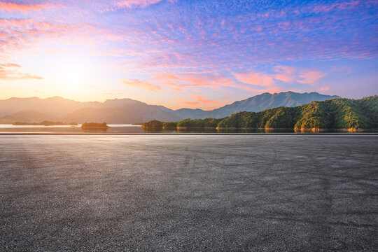 The colorful sunset sky and empty asphalt road with mountain view