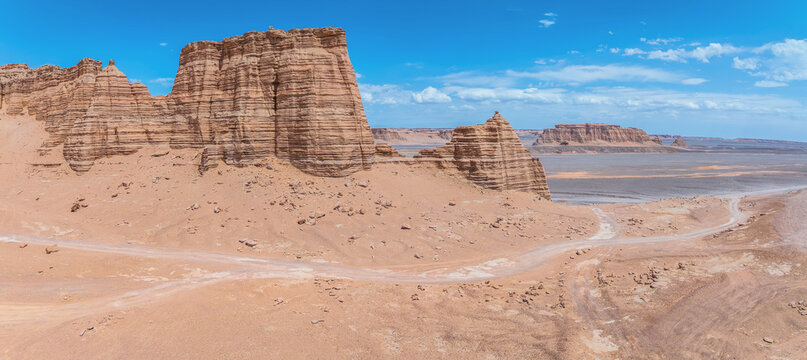 Winding road through the Yardan landform on a sunny day. The famous Dahaidao no man's land natural landscape in Xinjiang, China.