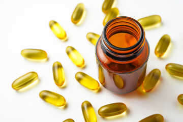 Vitamin capsules in a bottle, soft gels, Fish oil capsules, omega 3, omega 9, vitamin D, vitamin E