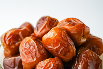Dates fruit sukari or kurma sukari, in bowl isolated on white background