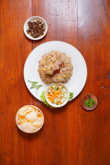 fried goat rice. cooked with lots of spices and goat meat. suitable to be served while hot or when it's raining. indonesian food on the table.