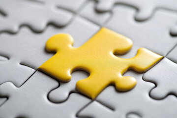 A Yellow Puzzle Piece Perfectly Fitting into a Larger Puzzle with White Pieces, Representing Tailored Customer Solutions
