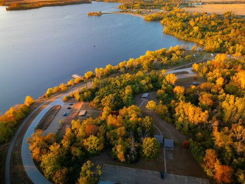 Aerial view of autumn landscape with vibrant foliage surrounding Big Creek State Park, Polk City, IA