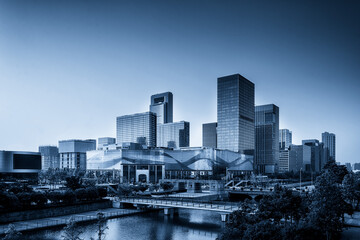 Obraz premium Modern Urban Skyline at Dusk Captured in Blue Tones