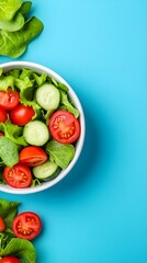 A bowl of salad with tomatoes and cucumbers on a blue background