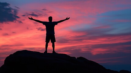 Silhouette of a Man at Sunset, Celebrating Achievement on a Rocky Peak