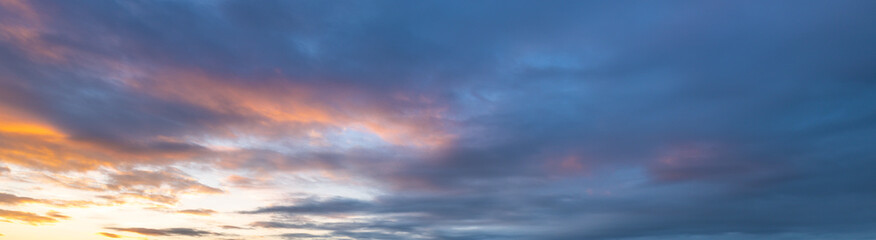 Beautiful blue sky with a few clouds and a pinkish hue
