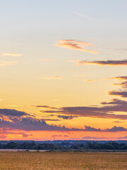 The sky is a beautiful orange color as the sun sets