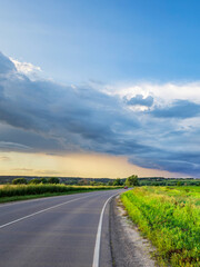 Road with a cloudy sky in the background