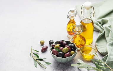 Assorted olives and olive oil on rustic table