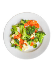 A portion of buckwheat porridge with chop on a white plate is isolated. Steamed carrots, cauliflower, and broccoli. Top view.