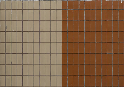The wall is covered with square ceramic tiles in two contrasting colors, beige and brown. Textured wall mockup. Close-up.