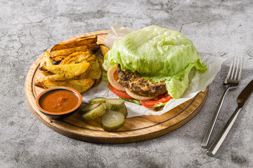 Lettuce wrapped hamburger, low carb burger with salad
