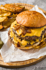 Smash burger with cheddar cheese and caramelized onions, served with fries