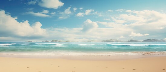 Fototapeta premium Tranquil sandy beach with gentle waves under a bright sky filled with fluffy clouds and a distant horizon ideal for vacation or relaxation themes