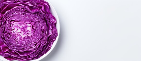 Fototapeta premium Chopped red cabbage in a white bowl on a light background showcasing vibrant purple hues with ample copy space on the right for text placement.