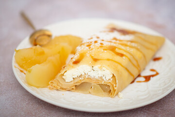 pancakes with apples on a white plate