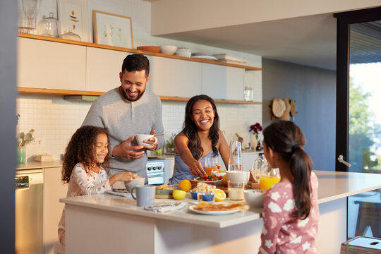 Happy multiethnic family enjoying healthy breakfast - Powered by Adobe