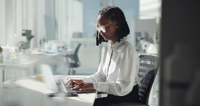 Science, laptop and typing with black woman in laboratory for clinical trial, healthcare and planning. Vaccine test results, medical program and pharmacy with person in hospital for research