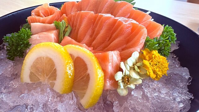 Salmon shashimi and vegetables in japanese restaurant.