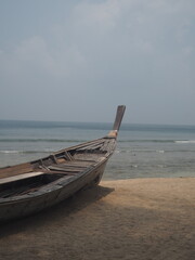 Fototapeta premium Thailand wooden boat beach overcast sand ocean 