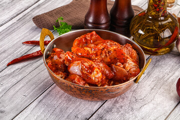 Raw marinated buffalo chicken wings