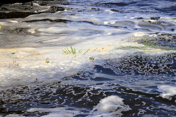 Dirty foam in wastewater, sewerage. Water pollution, wastewater treatment. bad ecology