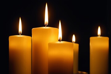 candles are lit in a row on a black background